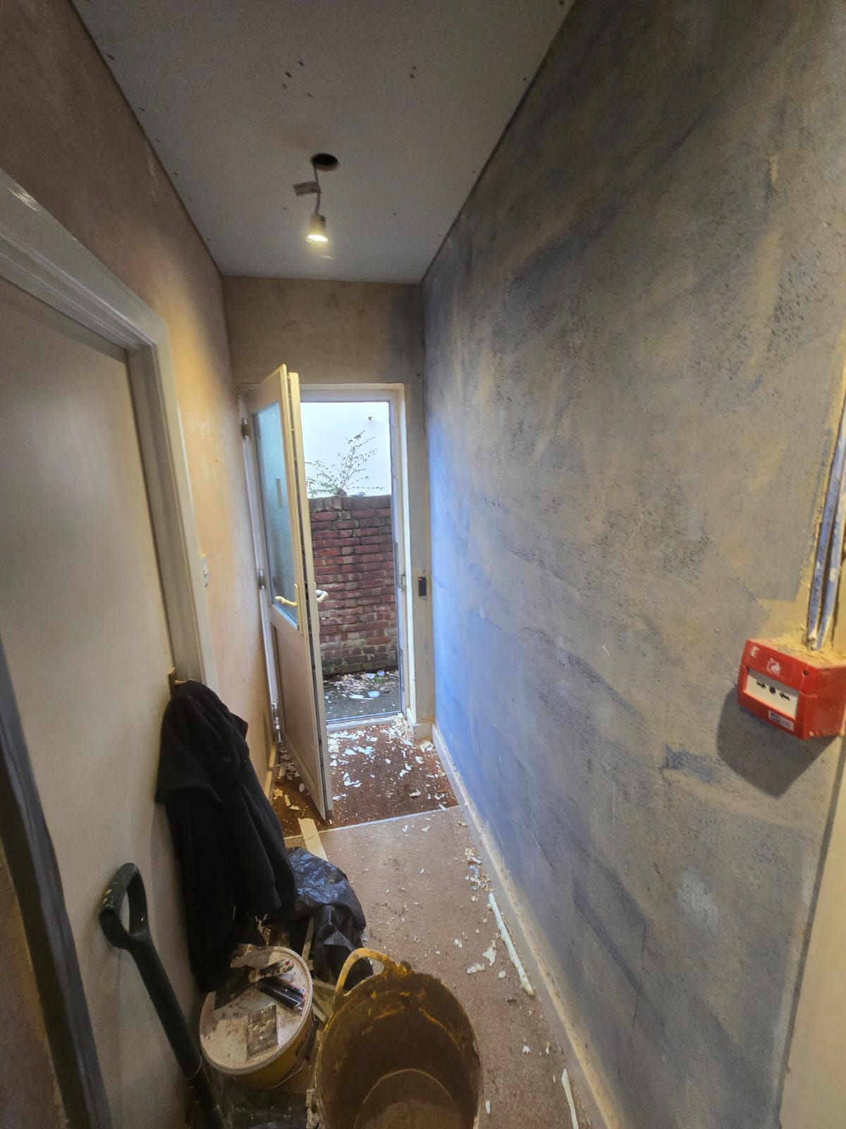 Rear hallway plastered with new external door