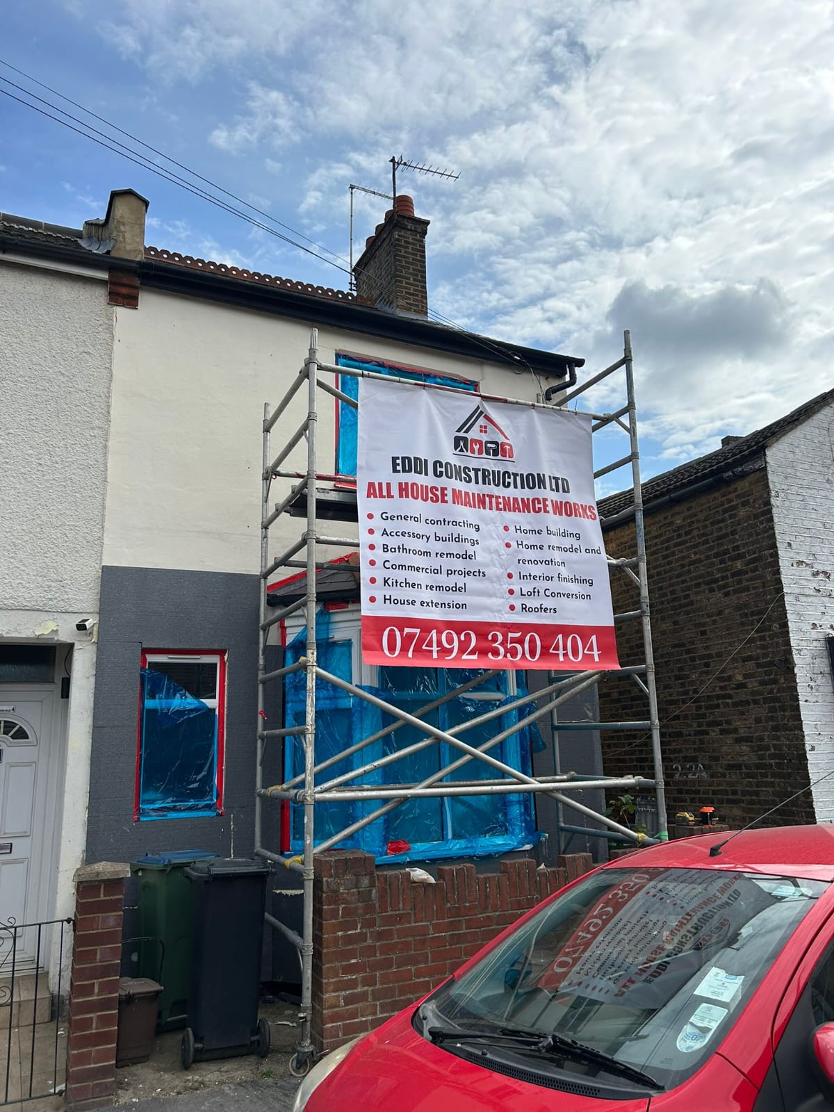 Eddi Construction Ltd banner on scaffolded property
