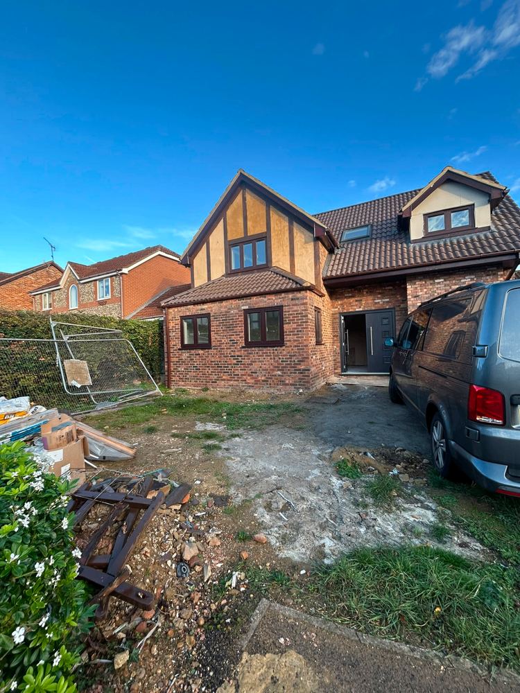 Detached house renovation — front elevation with new brickwork and rendering